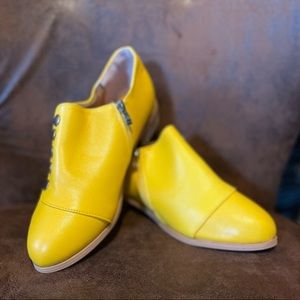Mustard Yellow booties with button detail on side. Size 38